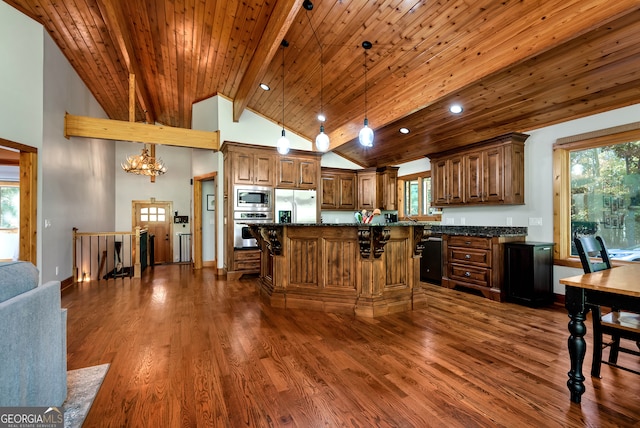 kitchen with appliances with stainless steel finishes, a breakfast bar, and plenty of natural light