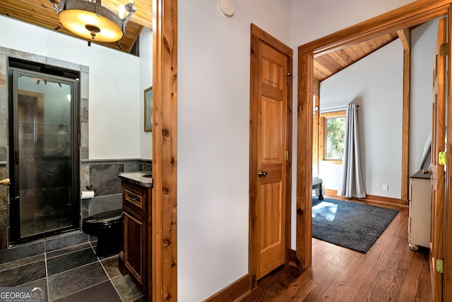 hall featuring wooden ceiling, dark hardwood / wood-style floors, and vaulted ceiling with beams