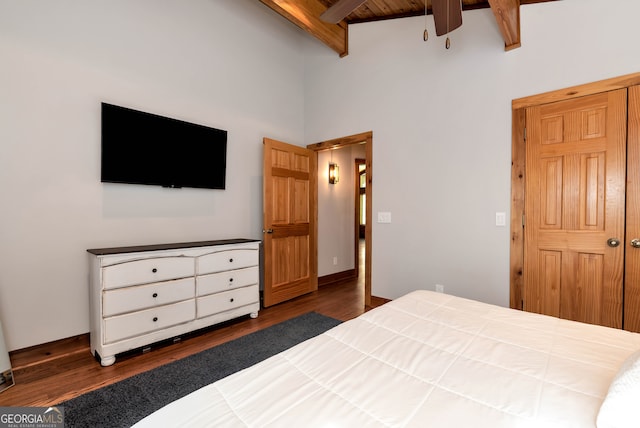 bedroom with high vaulted ceiling, dark wood-type flooring, and beamed ceiling