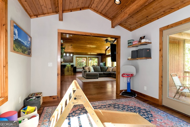 interior space with ceiling fan, dark hardwood / wood-style floors, wood ceiling, and lofted ceiling with beams