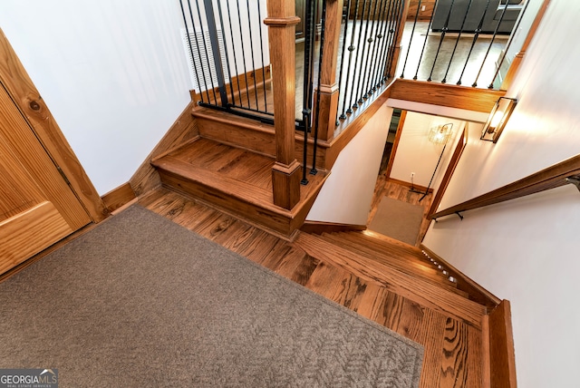 stairway featuring carpet flooring