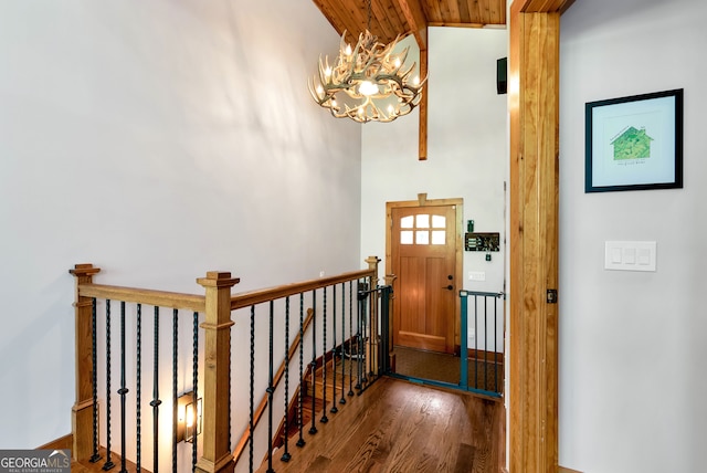 foyer featuring dark hardwood / wood-style flooring, a chandelier, vaulted ceiling, and wooden ceiling