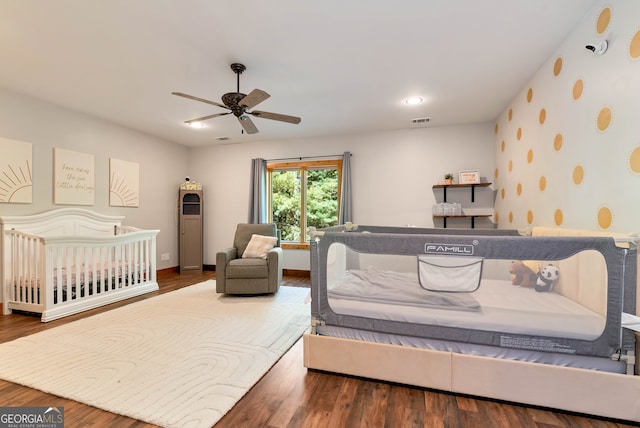 bedroom with wood-type flooring and ceiling fan