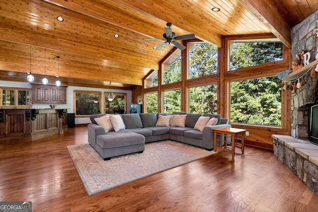 living room with dark wood-type flooring, wood ceiling, high vaulted ceiling, ceiling fan, and a fireplace