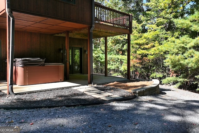 view of patio / terrace featuring a hot tub and a wooden deck