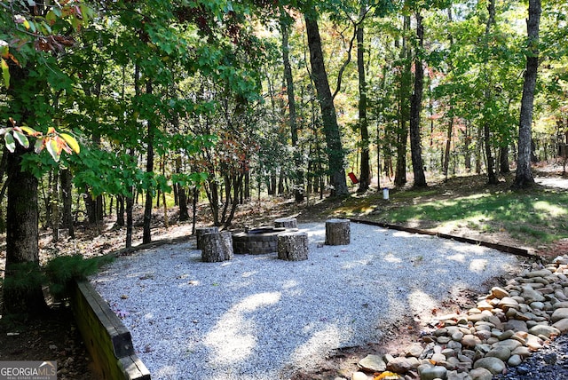 view of yard featuring an outdoor fire pit