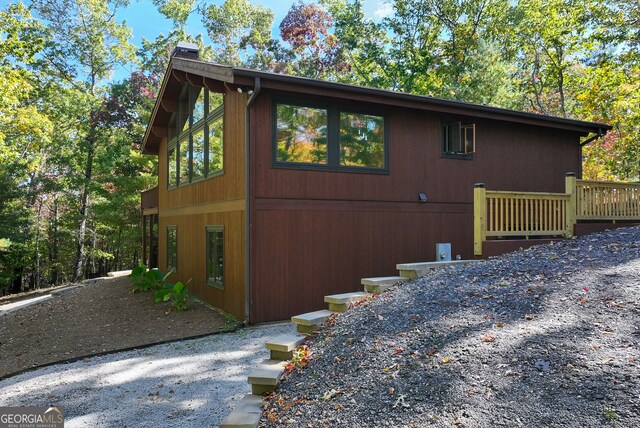 view of home's exterior with a wooden deck