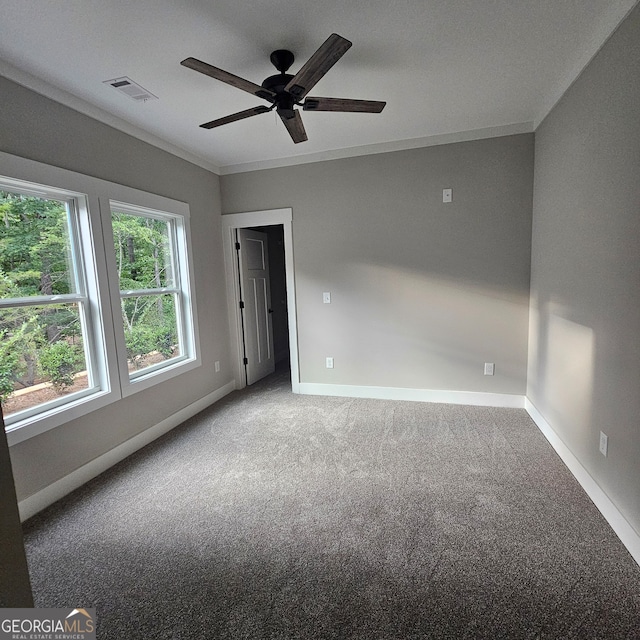 carpeted empty room with crown molding and ceiling fan