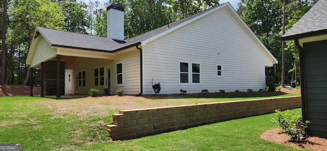 rear view of property with a yard