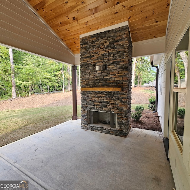 view of patio / terrace featuring an outdoor stone fireplace