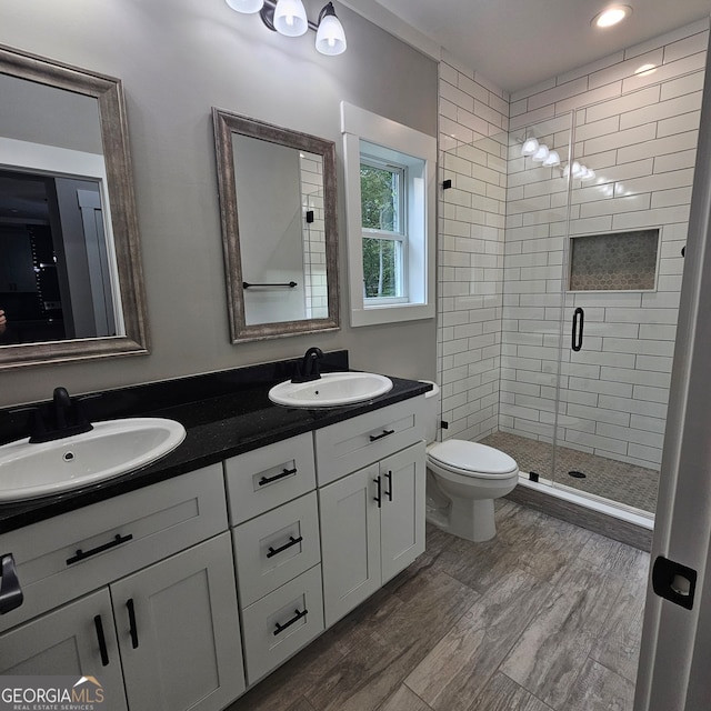 bathroom with vanity, an enclosed shower, hardwood / wood-style floors, and toilet