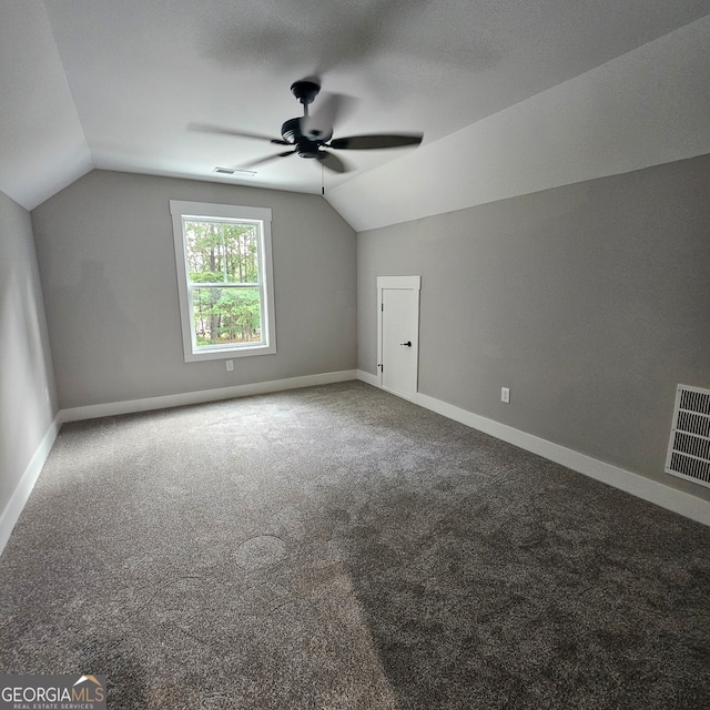 additional living space with carpet floors, ceiling fan, and vaulted ceiling