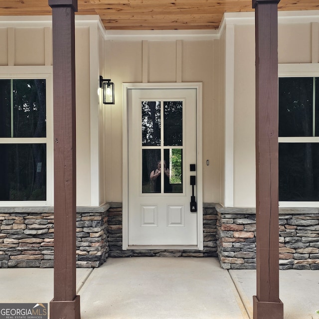 view of exterior entry with covered porch