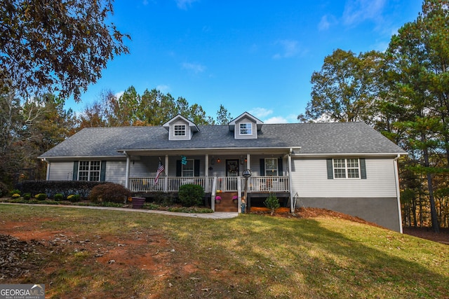 cape cod-style house featuring a front lawn and covered porch