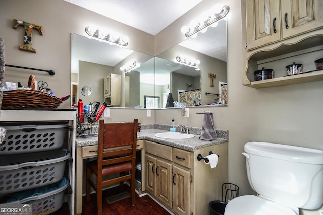 bathroom with wood-type flooring, toilet, and vanity