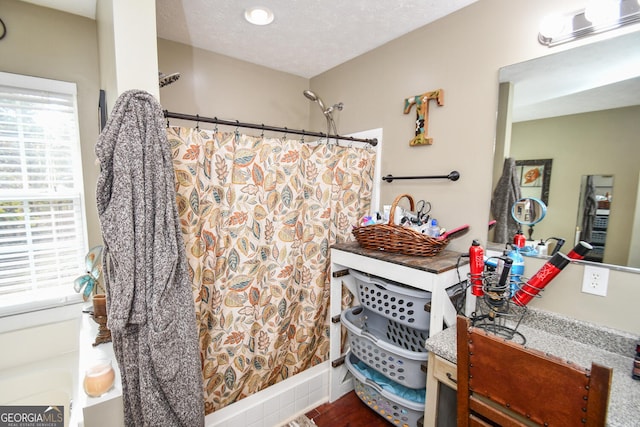 bathroom featuring hardwood / wood-style floors, walk in shower, and a textured ceiling