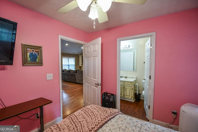 bedroom with dark hardwood / wood-style floors, ceiling fan, and ensuite bathroom