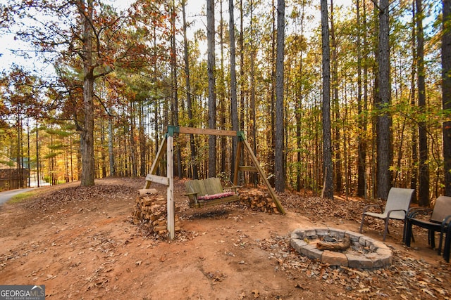 view of yard with an outdoor fire pit