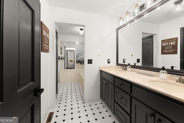 bathroom with a bath and vanity