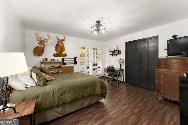 bedroom with a closet and dark hardwood / wood-style flooring