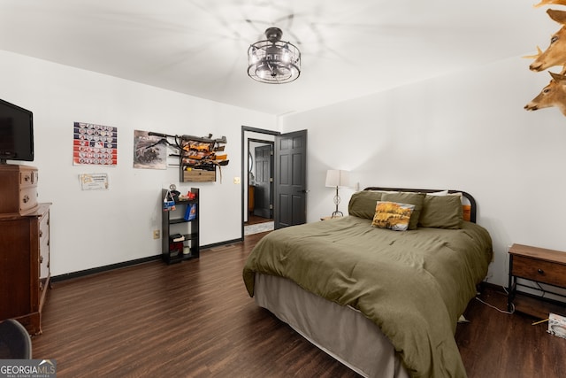 bedroom with dark hardwood / wood-style flooring