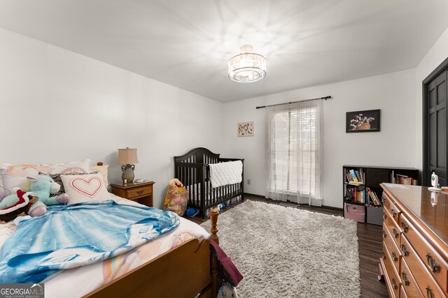 bedroom with dark wood-type flooring