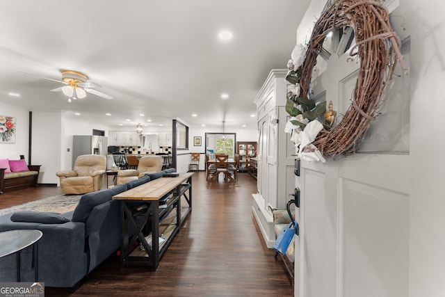 living room with ceiling fan and dark hardwood / wood-style floors