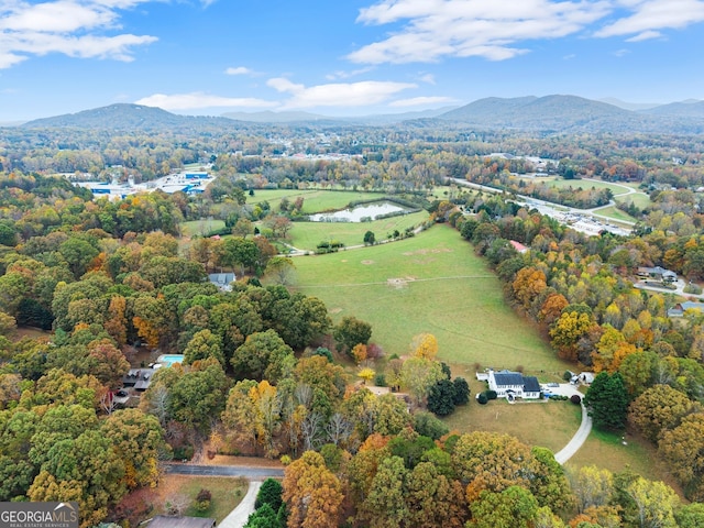 birds eye view of property with a water and mountain view