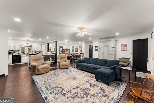 living room with ornamental molding, dark wood-type flooring, and ceiling fan