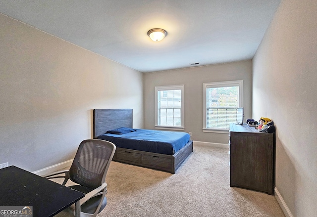 bedroom featuring light colored carpet