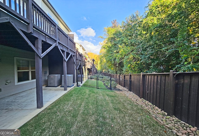 view of yard with central AC and a patio area