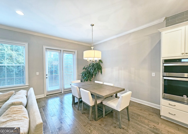 dining space with dark wood-type flooring and ornamental molding