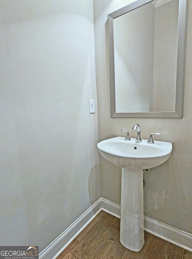 bathroom featuring wood-type flooring and sink