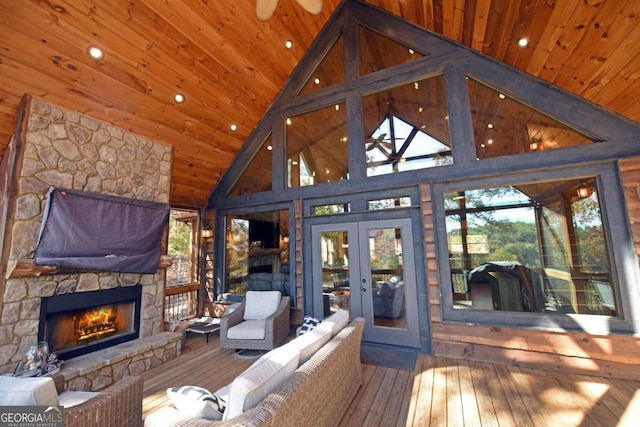 unfurnished sunroom with vaulted ceiling, a fireplace, wooden ceiling, and french doors