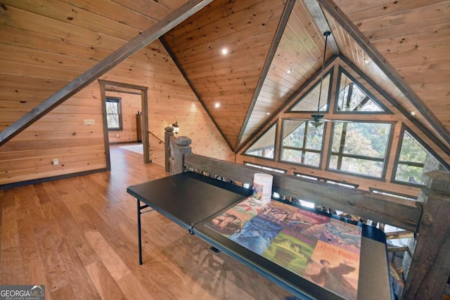 rec room with hardwood / wood-style floors, wood ceiling, and wooden walls