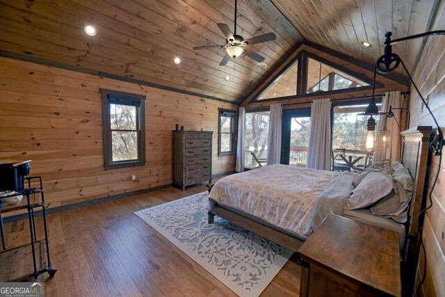 bedroom featuring multiple windows, wood walls, wood ceiling, and hardwood / wood-style flooring