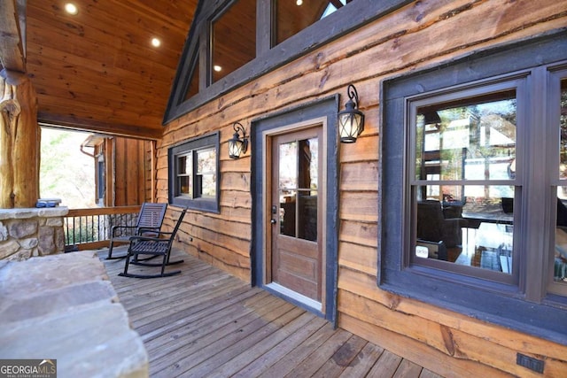 wooden terrace featuring covered porch