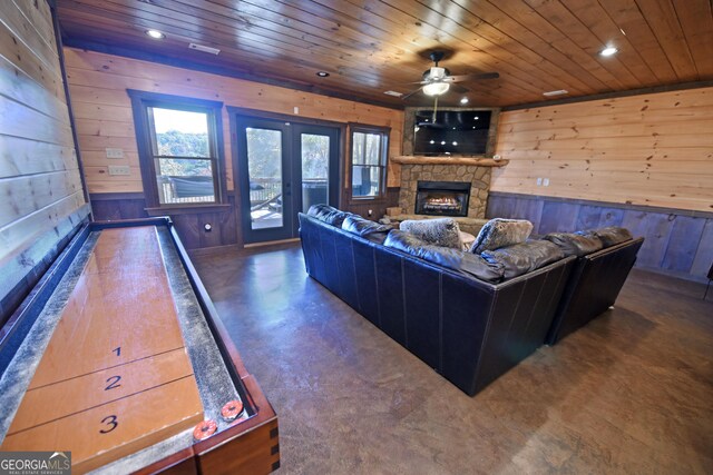 living room with a fireplace, ceiling fan, wooden walls, and wood ceiling