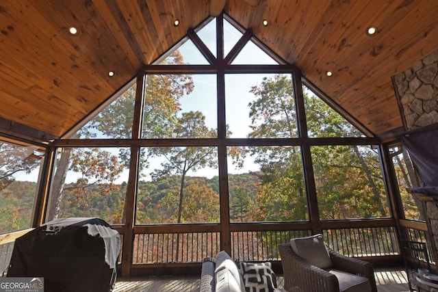 unfurnished sunroom featuring vaulted ceiling and wood ceiling