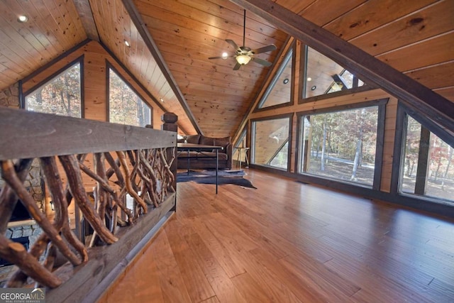 unfurnished living room with hardwood / wood-style floors, lofted ceiling with beams, a healthy amount of sunlight, and wood ceiling