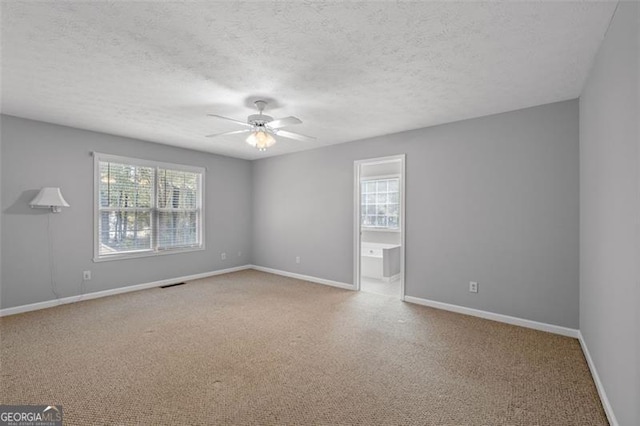 empty room featuring a textured ceiling and ceiling fan