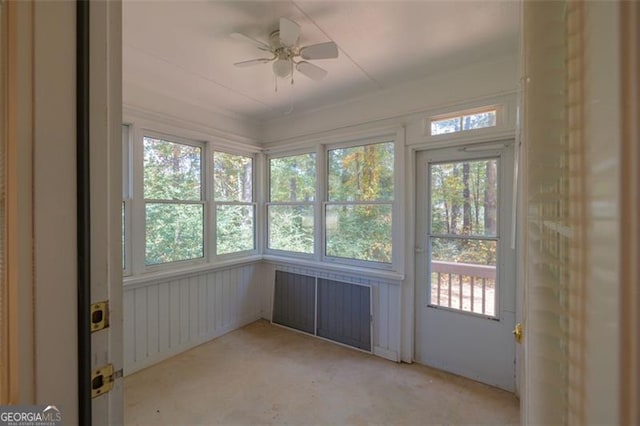 unfurnished sunroom with ceiling fan