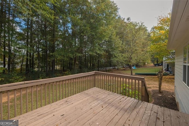 wooden deck featuring a lawn