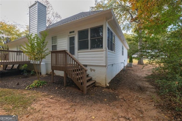 exterior space with a wooden deck and central AC unit