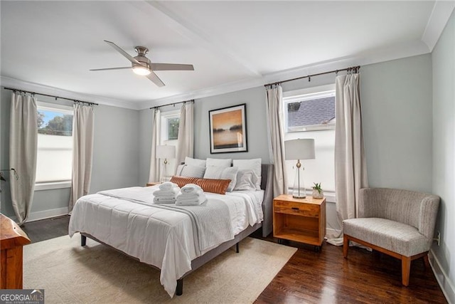 bedroom featuring ornamental molding, dark wood-type flooring, and ceiling fan