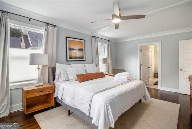 bedroom with ornamental molding, dark wood-type flooring, and ceiling fan