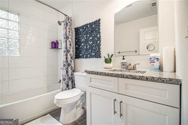 full bathroom featuring vanity, toilet, and shower / tub combo