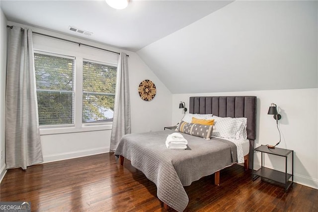 bedroom with lofted ceiling and dark hardwood / wood-style flooring