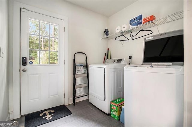 laundry area with dark hardwood / wood-style flooring and separate washer and dryer