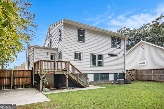 back of house featuring a yard, a patio area, and a wooden deck